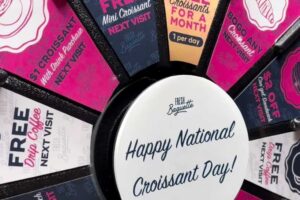 colorful prize wheel for National Croissant Day from Fresh Baguette